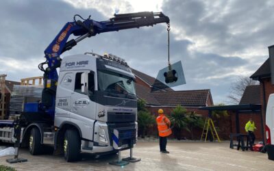 Crane installation of glass garage roof for a very special car to live.